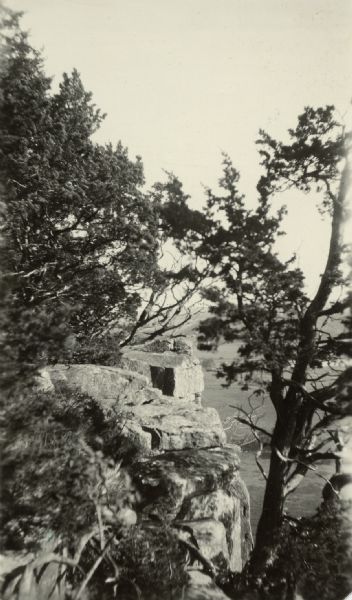 View from above towards a rock formation surrounded by trees. The valley is below in the bakground. Caption reads: "Columbia County - Richmond Memorial Park.
