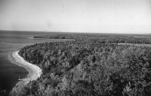 Elevated view of the park and the Lake Michigan shoreline. Description on the photograph record reads: "Looking Northeast from Sven's Tower."
