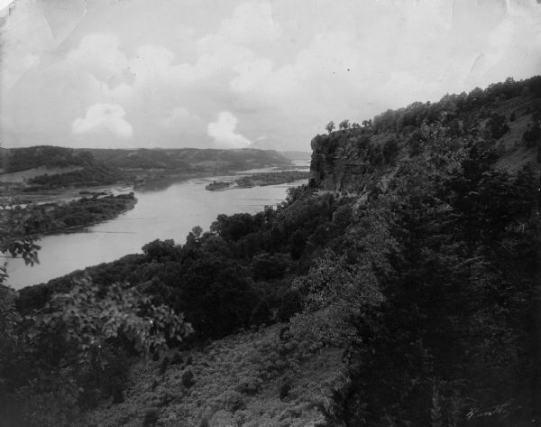 Elevated view of a cliff side overlooking a river. Caption reads: "Eagle Cliff, or Second Peak, in Perrot State Park. Donor Dr. Eben Pierce. Near Trempealeau, Wisconsin."