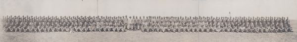 A panoramic group portrait of officers at Camp MacArthur. A dog is sitting on the ground in front of the group on the left.
