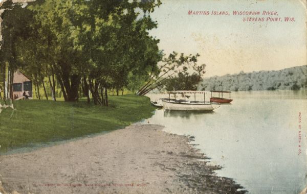 Colortone postcard of boats near the shore, and a building in the distance. Postcard was sent to Mr. William Kruschke of Burnett Jc., from Otto Young. Caption reads: "Martins Island, Wisconsin River, Stevens Point, Wis."