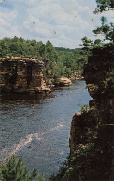 Elevated photographic postcard view across the Wisconsin River toward High Rock. Whitecaps are on the river.