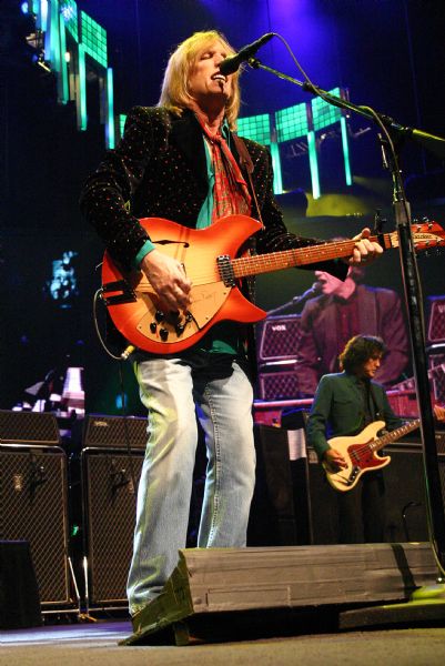 Tom Petty playing a Rickenbacker guitar and singing during a Tom Petty and the Heartbreakers concert at the Alliant Energy Center Coliseum.