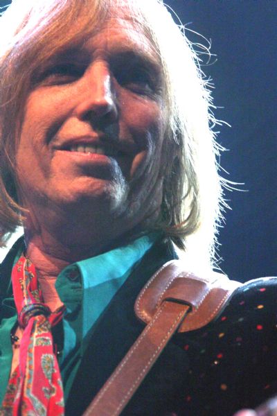 Close-up view of Tom Petty smiling during a performance at the Alliant Energy Center with his band Tom Petty and the Heartbreakers.