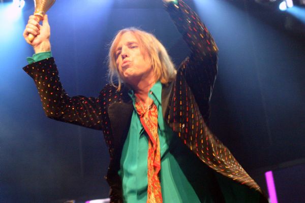 Tom Petty playing shakers during a performance at the Alliant Energy Center with his band Tom Petty and the Heartbreakers.