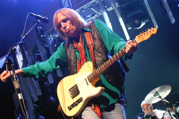 Tom Petty playing guitar during a performance at the Alliant Energy Center with his band Tom Petty and the Heartbreakers.