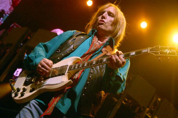 Tom Petty playing guitar during a performance at the Alliant Energy Center with his band Tom Petty and the Heartbreakers.