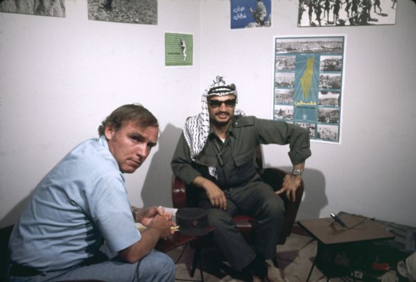 NBC producer and writer Bob Rogers is sitting with Yasser Arafat.