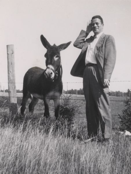 State Historical Society of Wisconsin Director Clifford Lord, paused on his way to a regional meeting posing with a donkey. He was like that.