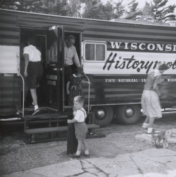 Vistors entering and exiting the Wisconsin Historical Society Historymobile parked at Point Beach State Park.