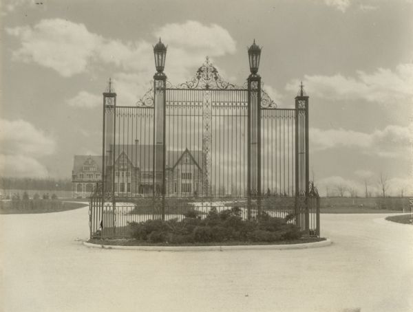 View of a wrought iron structure in an "island" garden in the middle of an entryway, with the Great Memorial Building in the background.