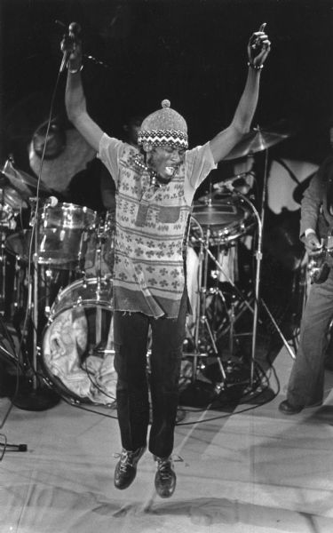Jimmy Cliff jumping up during a performance at the Orpheum Theater.