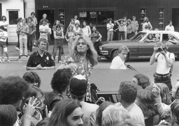 David Lee Roth, lead singer for the band Van Halen, getting into a limousine after visiting the Lake Street Station record store on State Street. The band was in town for a concert.