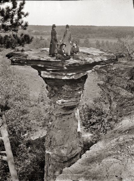 Four unidentified individuals on Stand Rock.