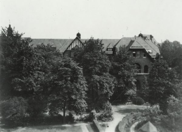 Elevated exterior view of a building, mostly obscured by trees. This is a teaching hospital in Breslau (Wroc&#322;aw), Poland, at which the medical staff was Jewish. The hospital was destroyed in 1938.