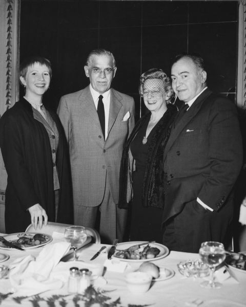 Julie Harris, Boris Karloff, Kermit Bloomgarden and his wife Virginia Kaye are standing near a table at the Thespian Theatre Club Award dinner. Harris and Karloff starred in the play "The Lark" which Bloomgarden produced.