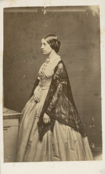 Three-quarter length studio portrait of Mary Lambert Allen. She is turned toward the left, and is wearing a dark-colored lace shawl over a light-colored dress.