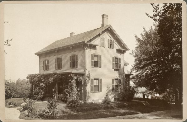 Exterior view of Grandmother Lambert's house. The front porch is covered with vines.
