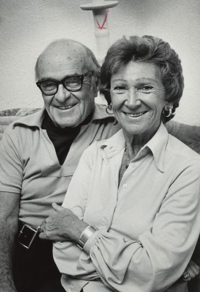 Portrait of a man and woman posing together. Caption reads: "Roy and Loretta Mulvey divide their time between Wauwatosa and St. Lucia."