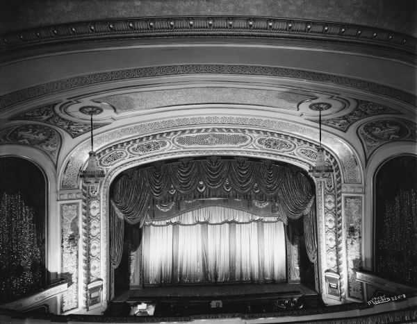 Elevated view of the stage at the Orpheum Theater, 216 State Street. A sign on the right side of the stage near the steps reads: "Rubber Tires."