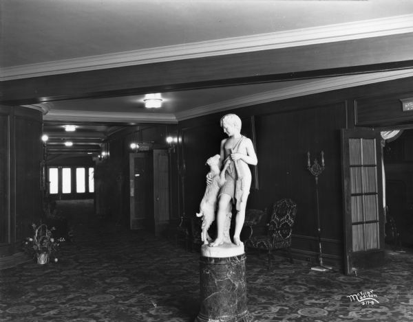 Orpheum Theater, at 216 State Street, showing foyer near doors to auditorium with a statue of a boy with a goat on a pedestal.