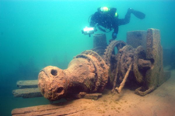 View of an archaeologist documenting the capstan and windlass from the wreckage of the schooner <i>Lucerne</i> at the bottom of Lake Superior.