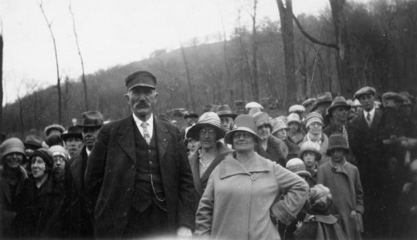 A crowd of people attending a reenactment of a ceremony in which Nicolas Perrot claimed the territory of the upper Mississippi River for France at Fort St. Antoine. Mr. and Mrs. Paulson are in front. 