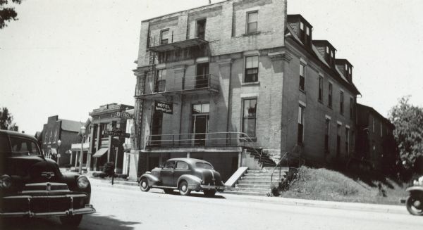 View across street towards the hotel. Caption in album reads: "Where I roomed 6-26 1946 while installing dial switchboard for Dairyland Milk Coop."