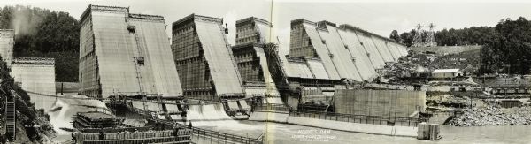Panoramic view of the construction of the Norris Dam, looking upstream. On the left the text reads: "West Bank," and on the right it reads: "East Bank."