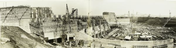 Elevated, panoramic view of the construction of the Pickwick Dam power house and spillway.