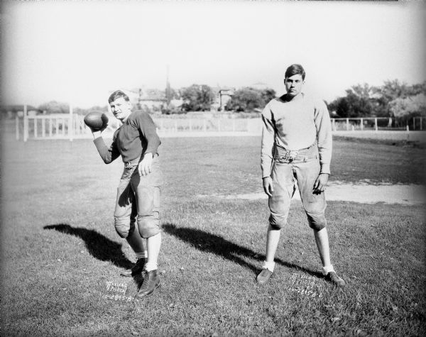 Wisconsin High School football players, Sheldon Loughborough and Bob Thistlethwaite, standing outdoors in uniform.