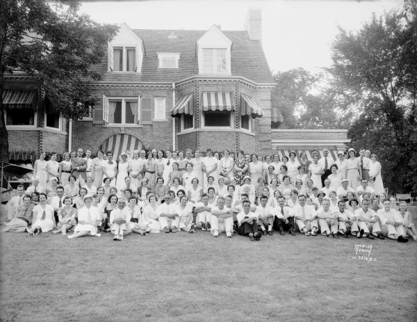 Group portrait of Manchesters Store employees picnic in front of Harry Manchester house.
