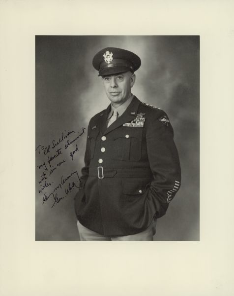Portrait of United States Army Air Force General George C. Kenney. He is wearing a dress uniform and cap. The handwritten inscription reads: "To Ed Sullivan/my favorite columnist/with sincere good/wishes/George Kenney/Gen. U.S.A."