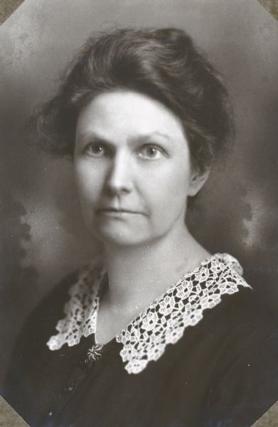 A head and shoulders studio portrait of suffragist Ada L. James.