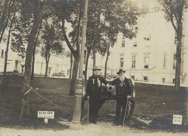 Handwritten text on back reads: "Mr. Prescott and Mr. Damon at Old Soldier's Home, Madison, Wisc." The building behind the men appears to actually be the third Wisconsin State Capitol.