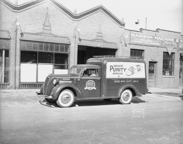 Gardner Bakery truck and driver parked in front of Madison Machine and Engine Company, 844 E. Washington Avenue. Taken for Diamond T Truck Sales.