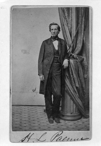 Full-length studio portrait of Henry Palmer. Cabinet card, with signature at bottom.