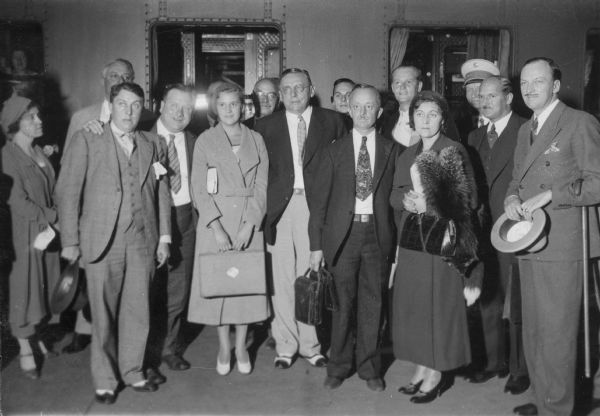 Group portrait, with Sigrid Schultz on the far left, and of Chicago Mayor A.J. Cermak standing in the center. Typewritten text on back of photograph reads: "Der Oberbürgermeister von Chicago, A.J. Cermak, 1st am 22.August 32 auf seiner europaischen Rundreise in Berlin eingetroffen. A.P. Bild zeigt das Eintreffen des Oberbürgermeisters von Chicago am Bahnhof Friedrichstrasse in Berlin. (Bürgermeister Cermak Mitte). Text ohne Gewähr."