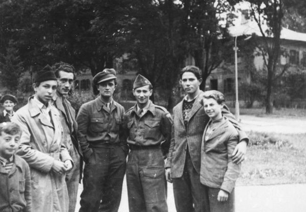 Louis Koplin (third from right) and friends, including brother Bernie Koplin (second from right). Koplin is dressed in the uniform he work while working for the American Jewish Joint Distribution Committee; Munich.