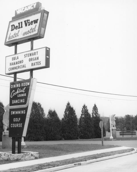 View from road towards a sign for the Dell View Hotel • Motel.