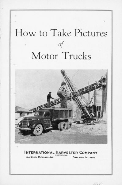 Front page of 4-page brochure with description of photographic rules. Features a photograph of a man standing on top of a dump truck holding a shovel, while a steam shovel is loading up the bed of the truck with material. Conveying machinery and industrial buildings are in the background.