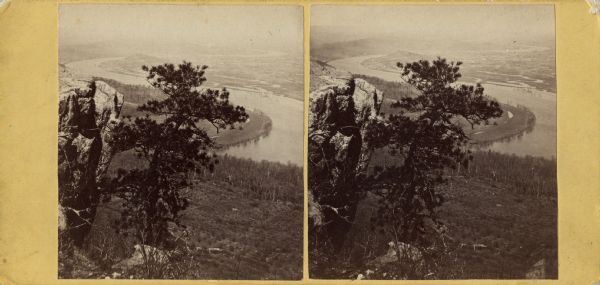 Elevated, stereograph over a tree towards a valley with the Tennessee River running through it. On the left is a rock outcropping.