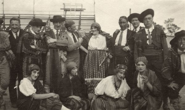 Informal portrait of an opera company in costume for an unidentified performance. Included in the portrait are: Bruno Steindel, Irving Lavitz, Phil Fine, Max Taft, "Pudgee," Mary Derman, Desere Defrere (?), Fuhrman, Nascimbene Tomasso, Mae Rose, Julia Hart, Lina Calvo, and Mary Guillermo.