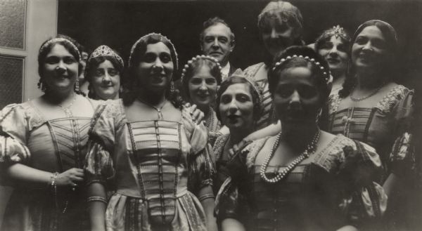 Group of opera singers in costume, perhaps at rehearsal or backstage at a performance. They are: Leota Cardati, Ilma Bayle, Rosa Salvina, Vassie Darnelle, Harry Beatty (Technical Director, Chicago Opera), Sadelle Kaplan, Constance Bitterl, Emma Bucci, Lina Calvo, and Mary Guillermo.