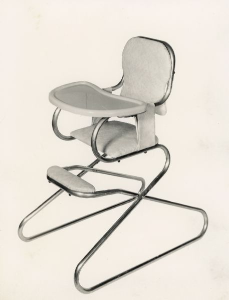 Metal baby high chair, capable of being disassembled and folded for easy transport. Taken for Halbert M. Wood, WooDick Corporation.