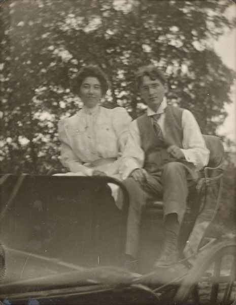 Olivia Monona sitting in a carriage with her first husband, Clarence Johnson.