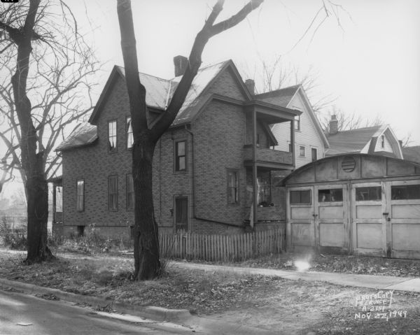 Rogers Street side of house, at 1452 Jenifer Street, with Trachte garage.