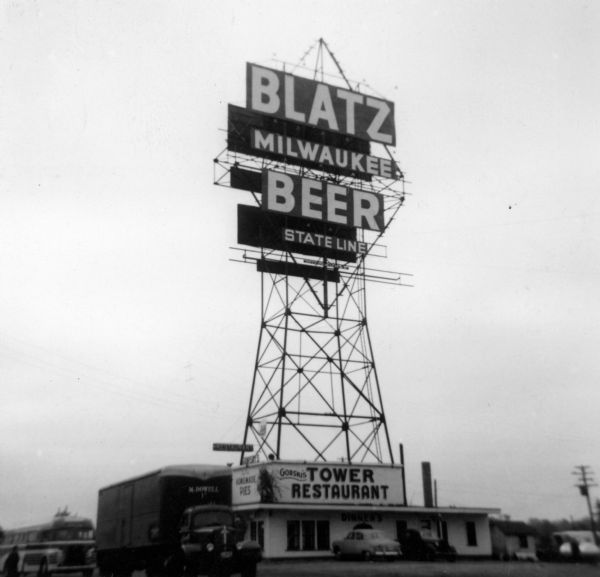 Large Blatz Beer sign on top of Gorski's Tower Restaurant at the Wisconsin state line. The sign reads: "Blatz Beer Milwaukee State Line."