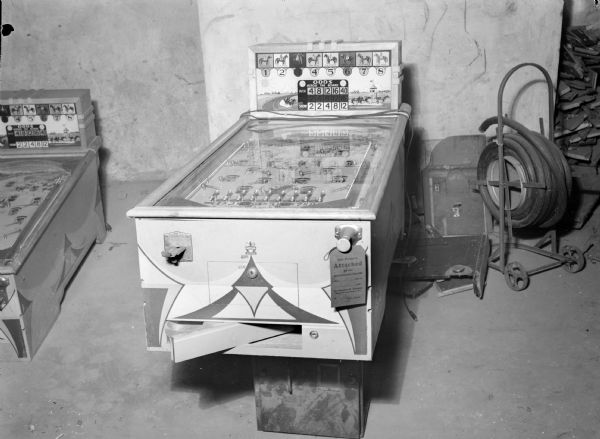 "Daily Races" pinball machine, manufactured by Gottlieb in 1936. The playing surface shows horse racing scenes. The machines was likely seized as a gambling device by the Dane County Sheriff's Department.
