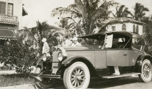 Renee Harris and Marvin Simmons with a 1925 Buick roadster at Harris' Palm Beach home.